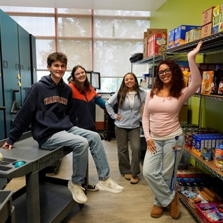 four students standing in the Campus Cupboard