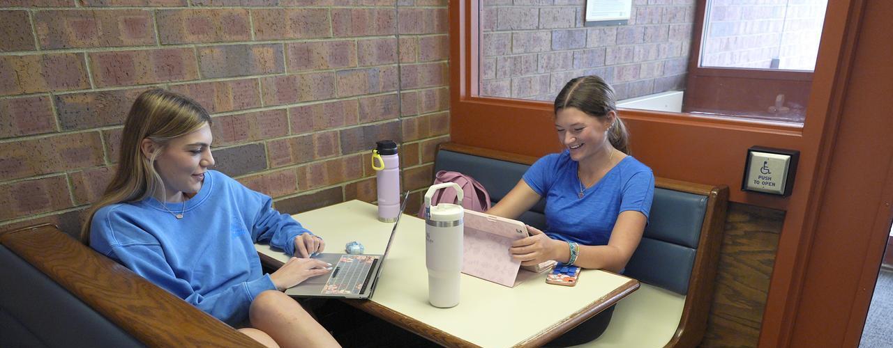 DEA students working on homework in hallway