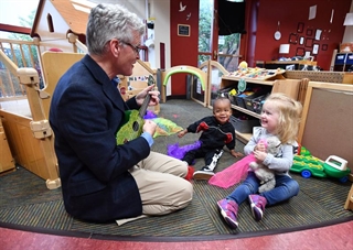 Teacher playing music with child