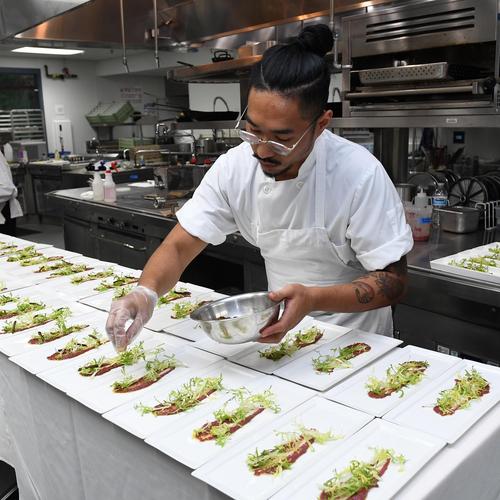 Chef plating food in culinary kitchen