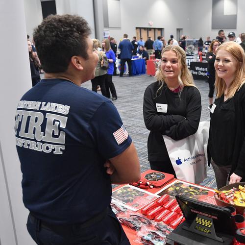 Students talking with employer at career event