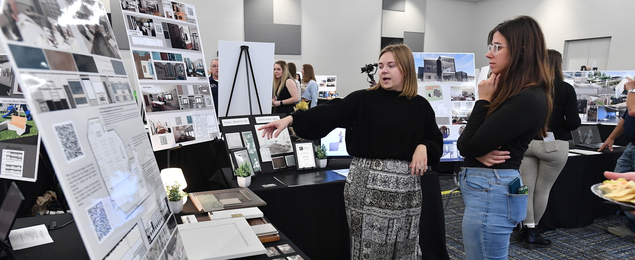 Student presenting project at Architectural Drafting Portfolio Show