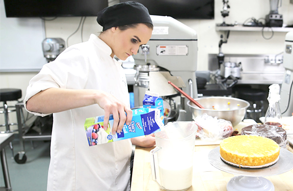 Student mixing ingredients in WCTC Baking and Pastry Lab