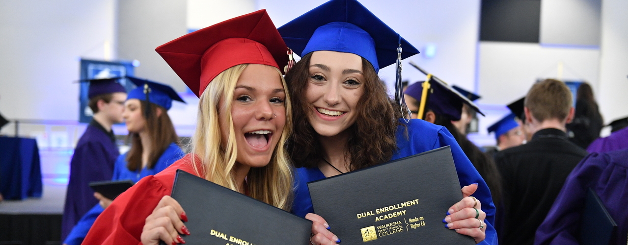 Dual Enrollment Academy students in caps and gowns at graduation