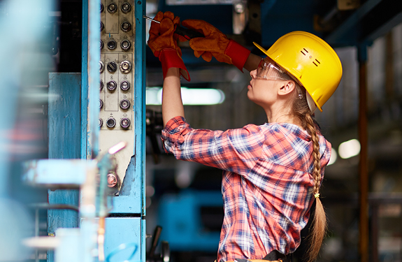 Woman working on electrical components at job site
