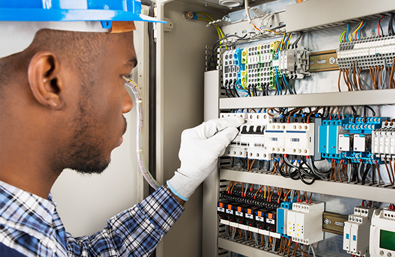 Electrician at electrical panel