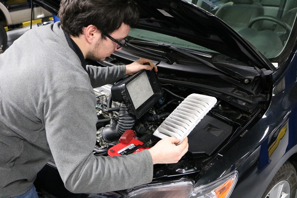 Student checking engine air filter