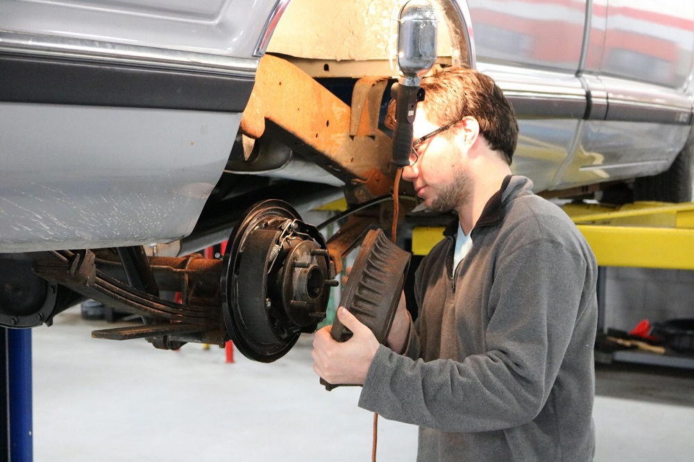 Student rotating car tire