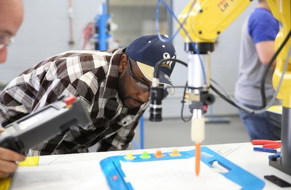 Student observing robotic equipment