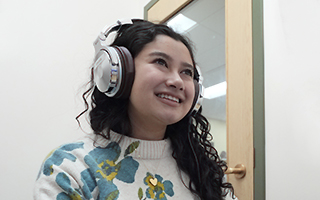 Student wearing headphones at computer