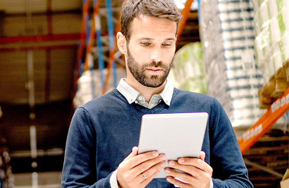 Man in warehouse with tablet